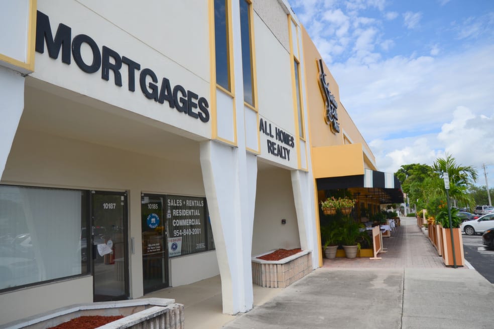 A building with a sign that says mortgages, representing a financial institution offering home loan services.