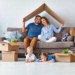 happy family mother father and children move to a new apartment with the help of reputable mortgage company