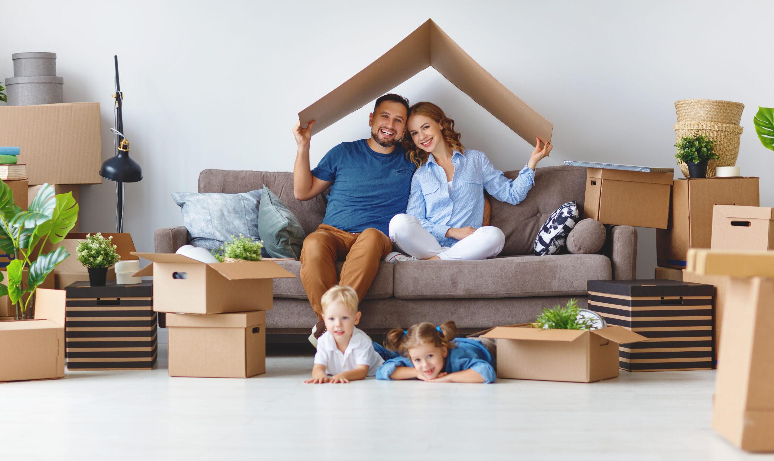 happy family mother father and children move to a new apartment with the help of reputable mortgage company
