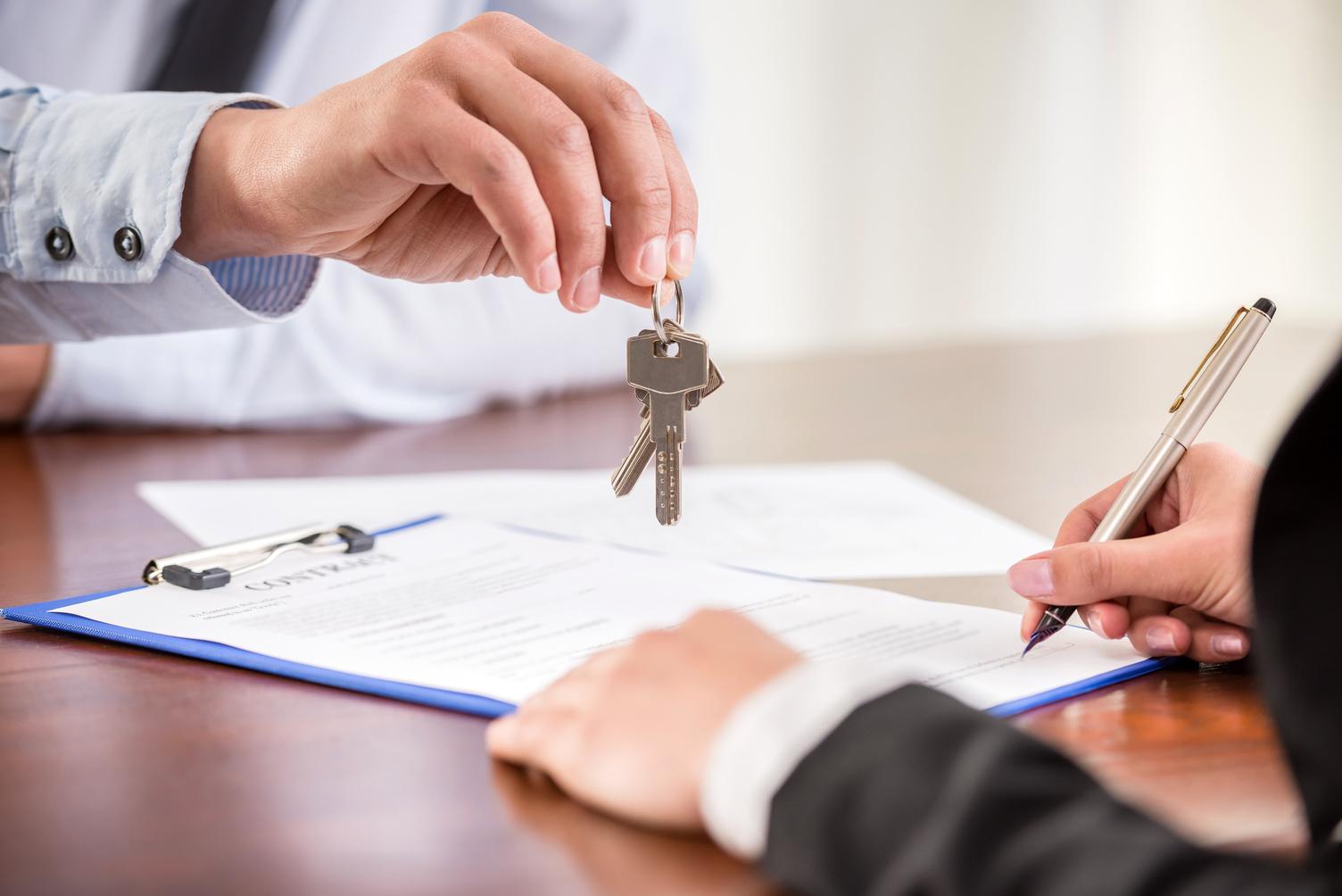 Home Mortgage lender giving house keys to owner