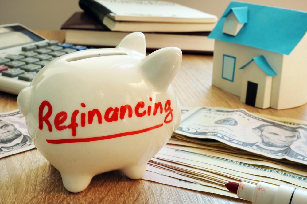 Refinancing written on a piggy bank.