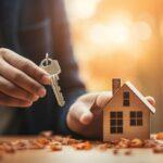 home buyer holding house model and keys in hand.