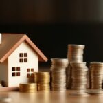 wooden house and money on a table- home financing