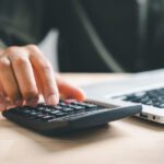 man working on home refinance calculations
