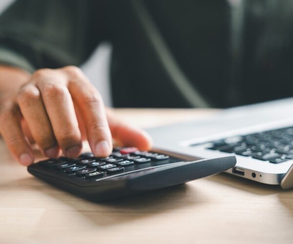 man working on home refinance calculations