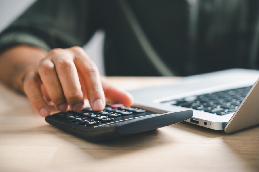 man working on home refinance calculations