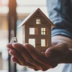fha loan concept. hand holding house model