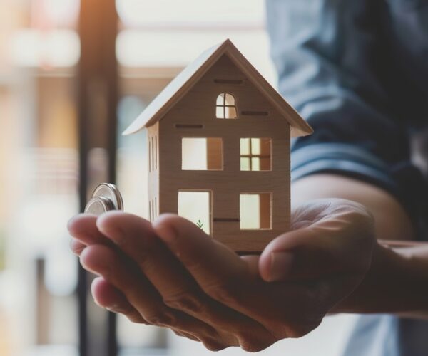 fha loan concept. hand holding house model