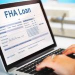 An agent filling FHA Loan Federal Housing Administration Lending form on laptop