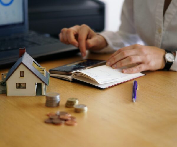 A closeup shot of a person thinking of buying or selling a house