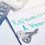 Refinancing a home concept. House keys, calculator and money