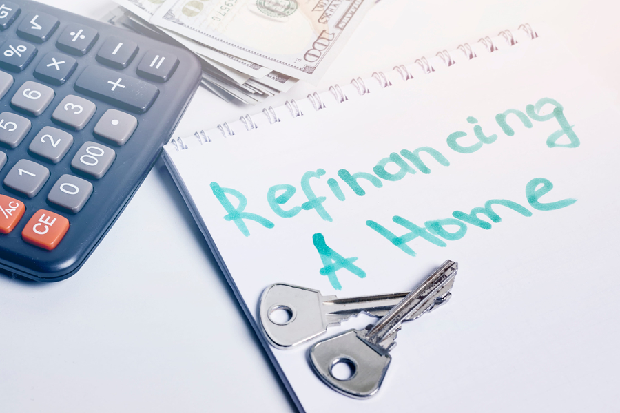 Refinancing a home concept. House keys, calculator and money
