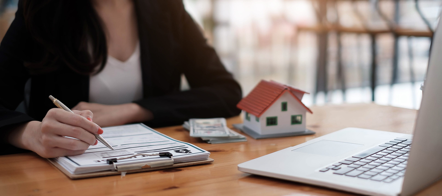 Woman reviewing mortgage and home buying documents